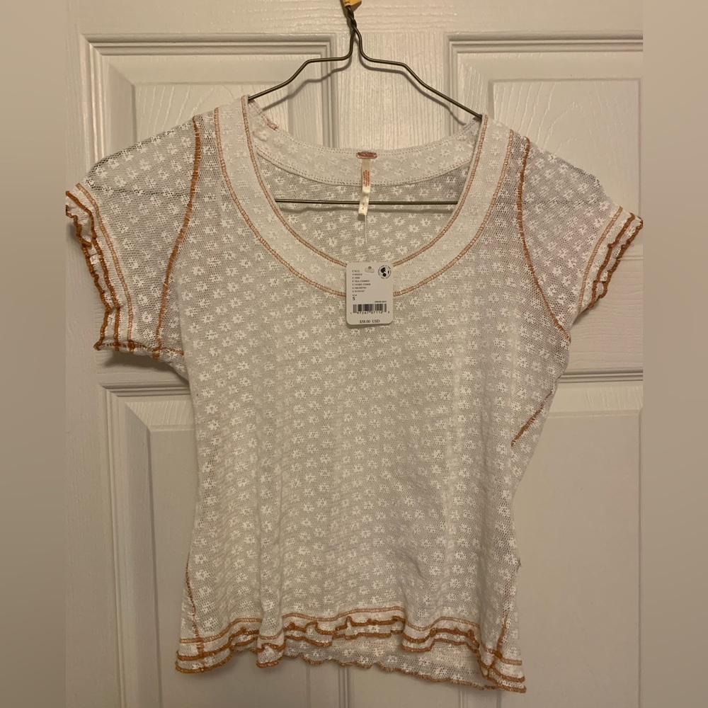White lace free people tee with a mustard yellow trim. NWT never been worn.